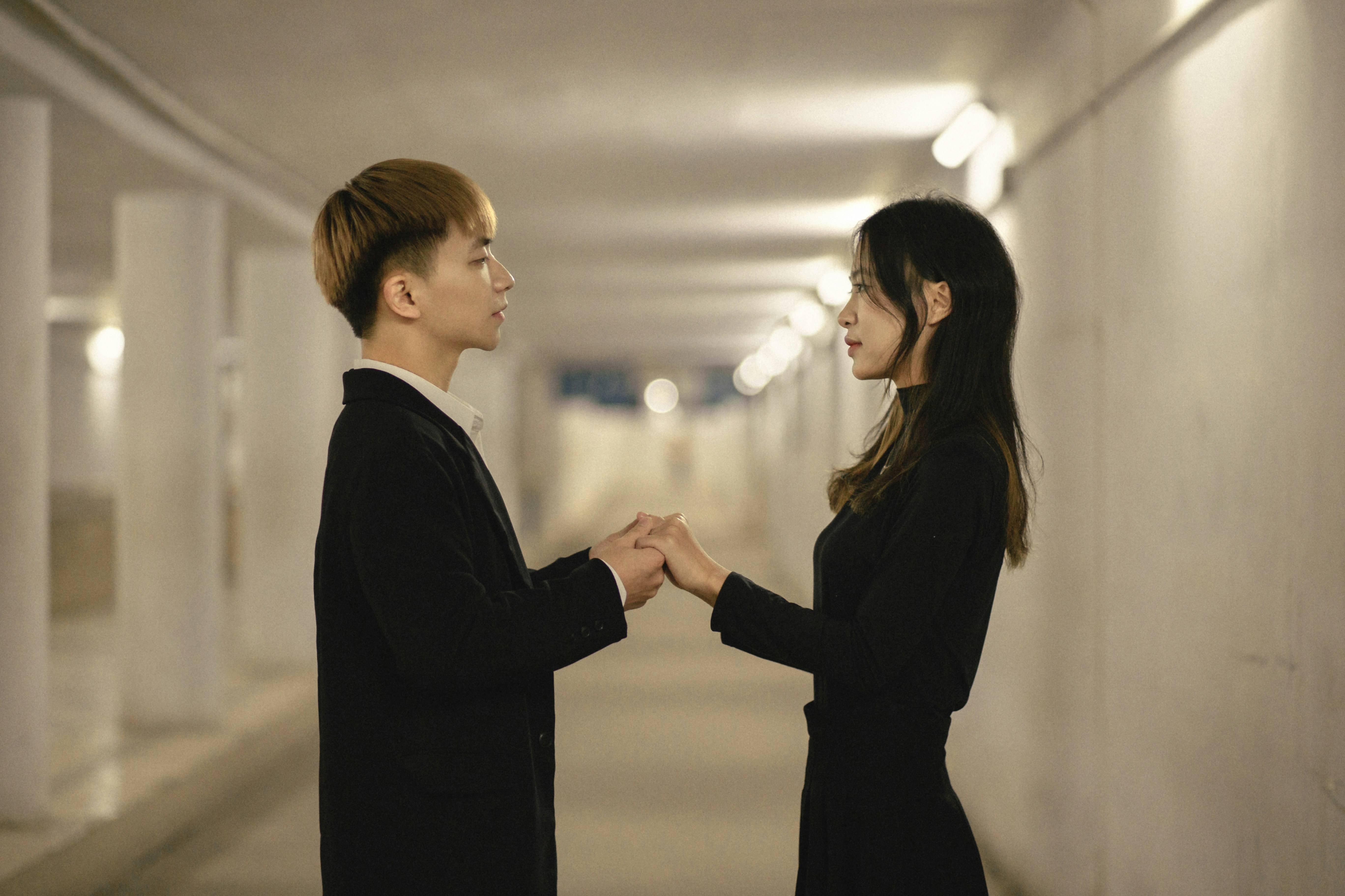 a man and a woman standing in a hallway
