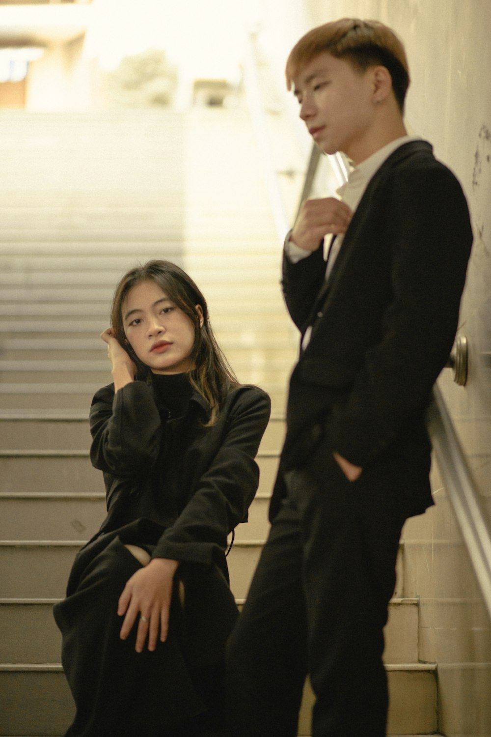 a man standing next to a woman on a stairway