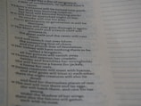 The image displays a close-up view of a page containing text, possibly from a religious or literary book. The text is arranged in verses and includes words like 'Edom's streams', 'desert owl', and 'thorns'. The text appears to have a poetic structure, with lines aligned and some parts featuring indented formatting.