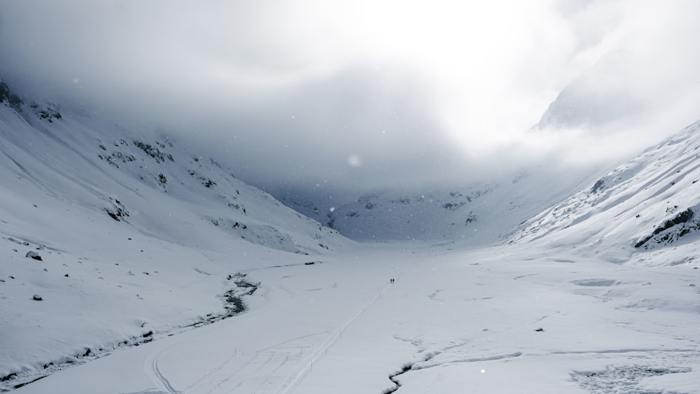 a snow covered mountain with tracks in the snow