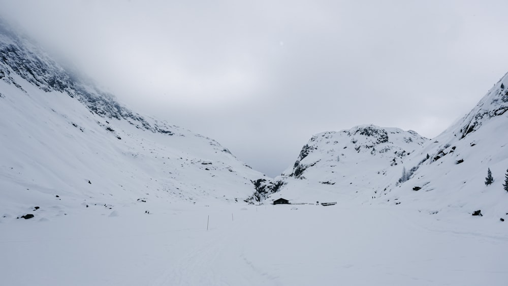 a person on skis in the snow near a mountain