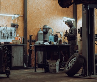 a man working on a machine in a garage