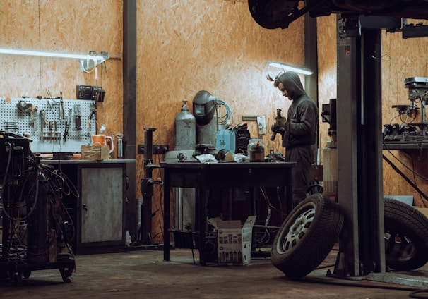 a man working on a machine in a garage