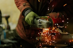 a person using a grinder on a piece of metal