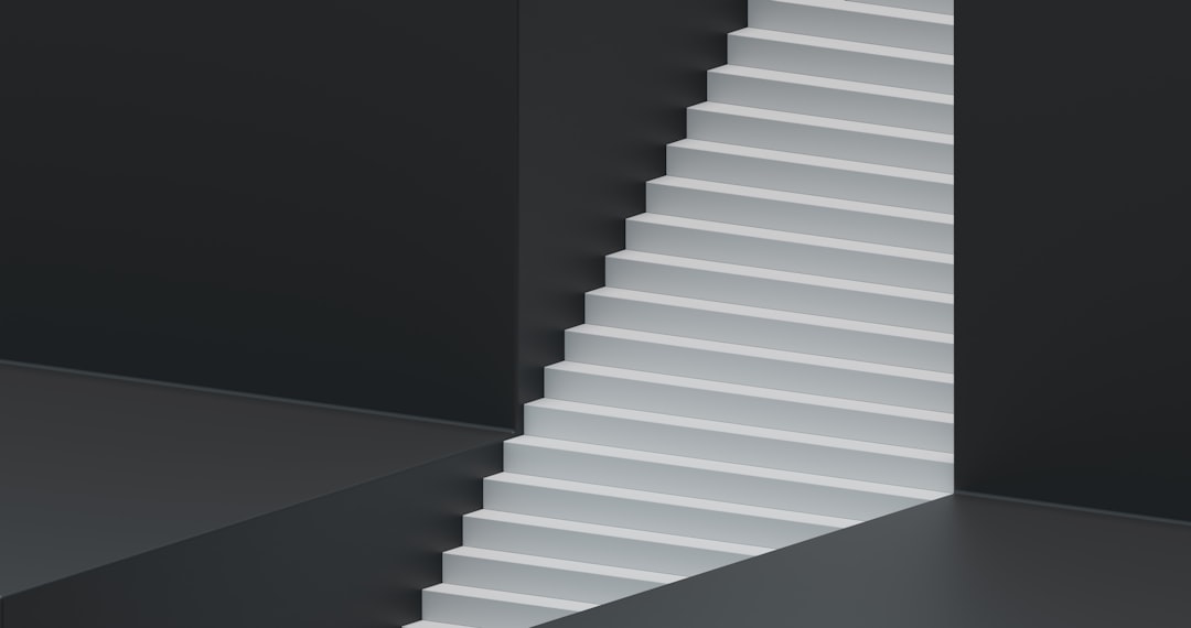 a white staircase in a black room,