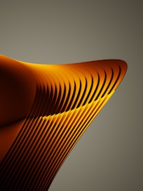 a close up of a curved object with a gray background