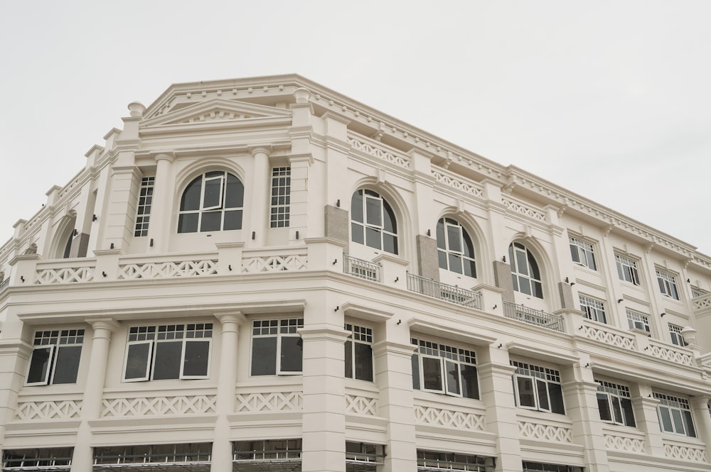 a large white building with many windows and balconies