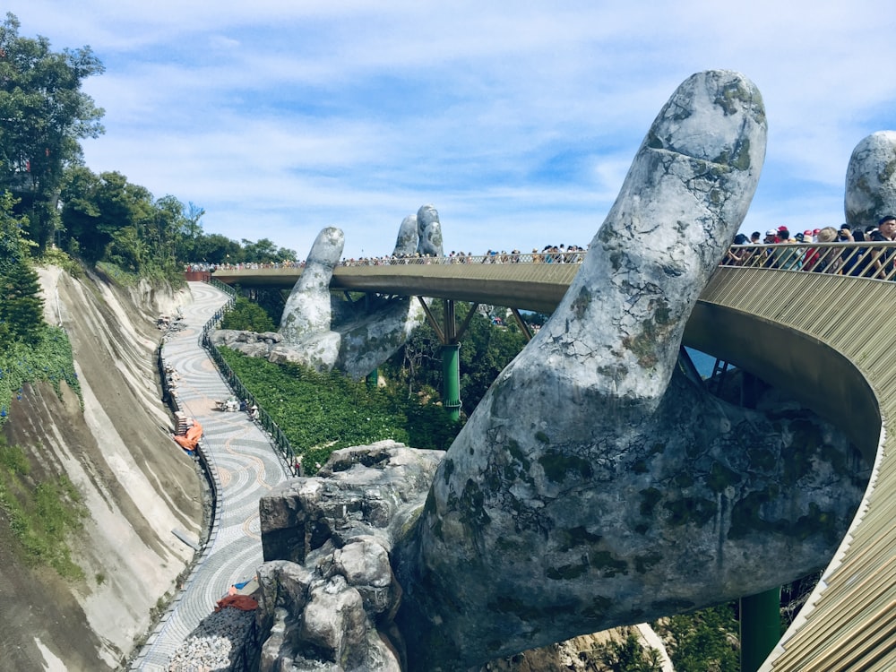 a bridge over a river with people standing on it