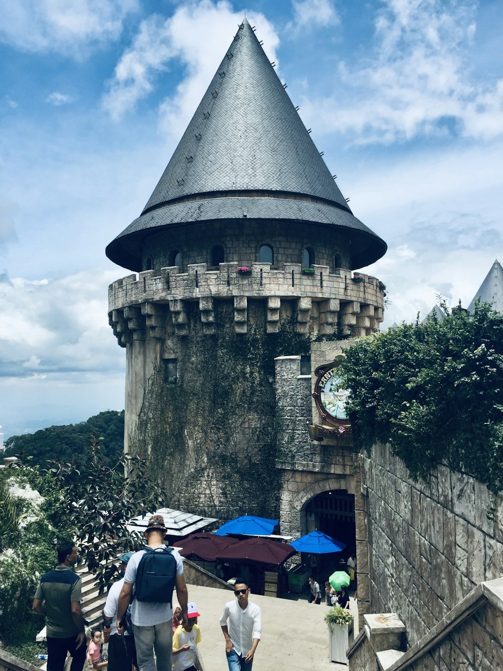 a group of people walking up a ramp towards a castle