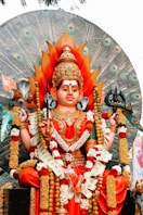 a statue of a hindu god sitting on a bench