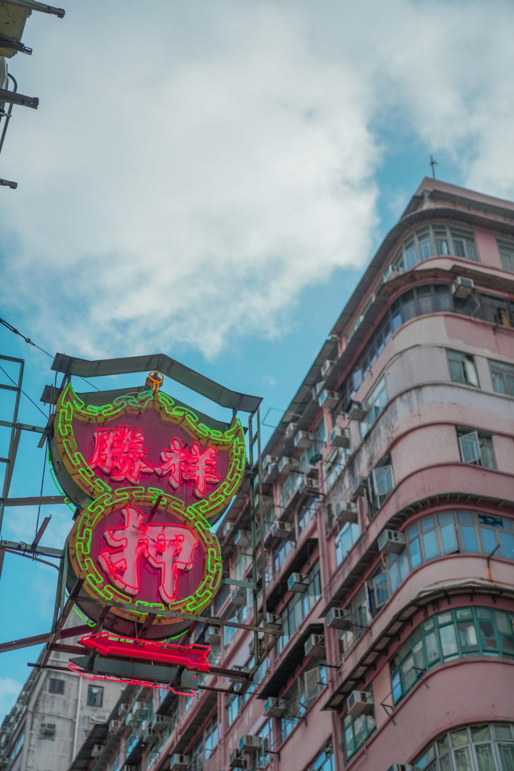 a building with a neon sign in front of it