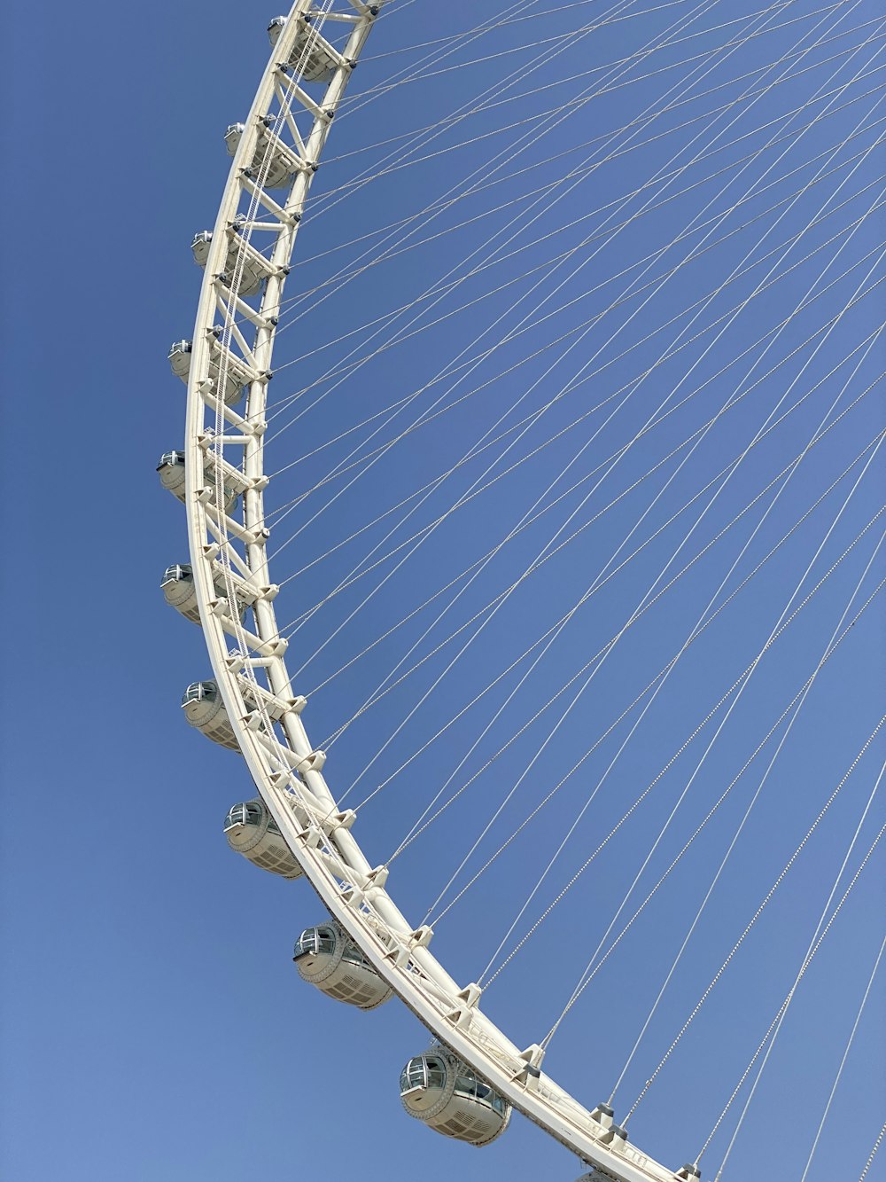 a large white ferris wheel against a blue sky