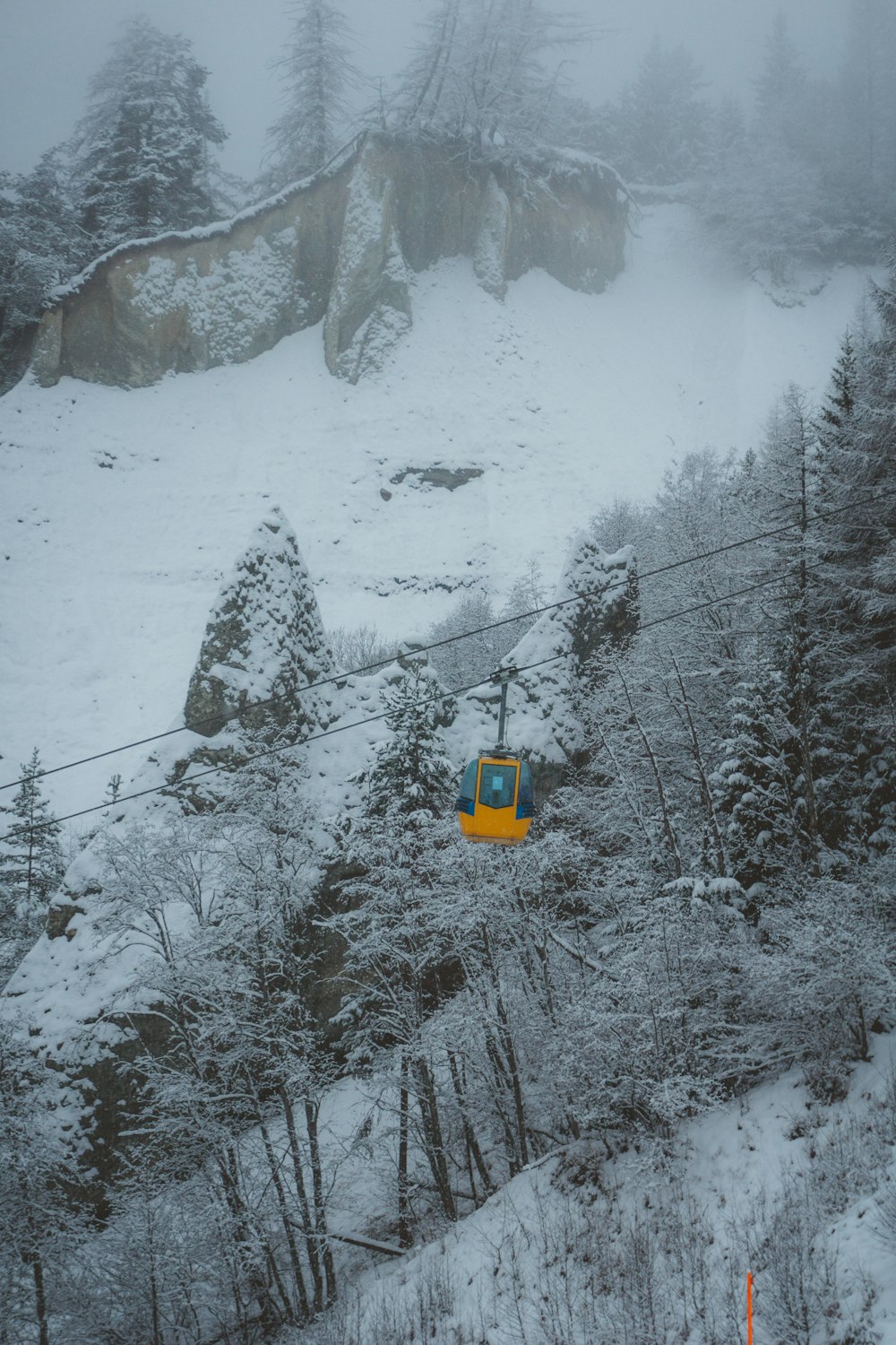 a ski lift going up a snowy mountain