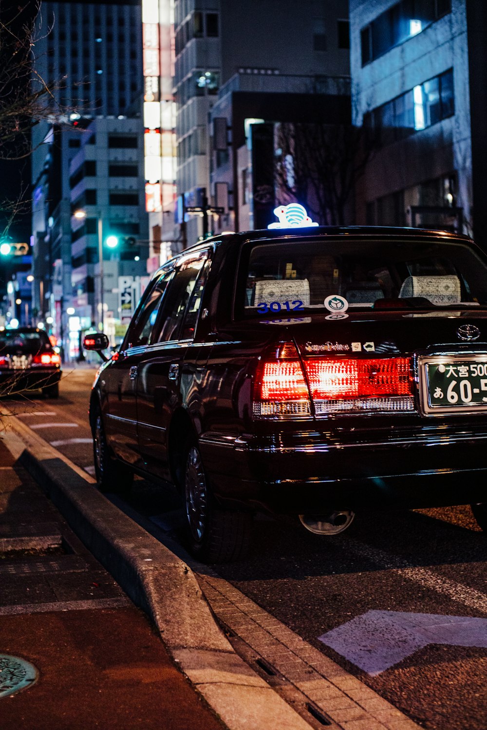 a car parked on the side of the road at night