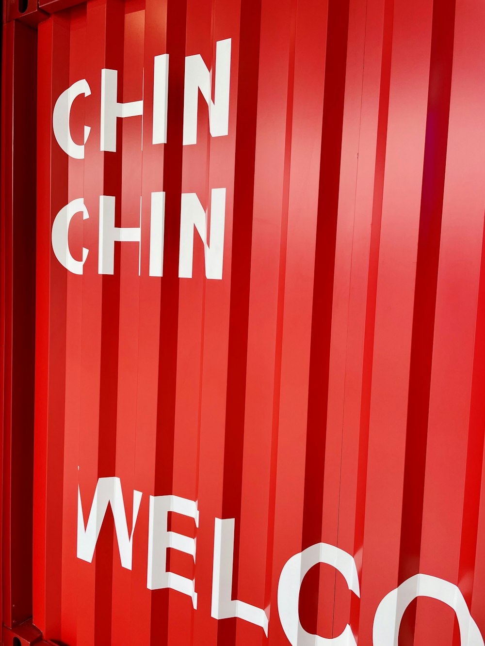 a red container with the words welcome written on it