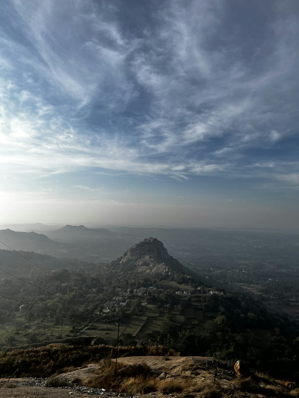 a view of a mountain with a few clouds in the sky