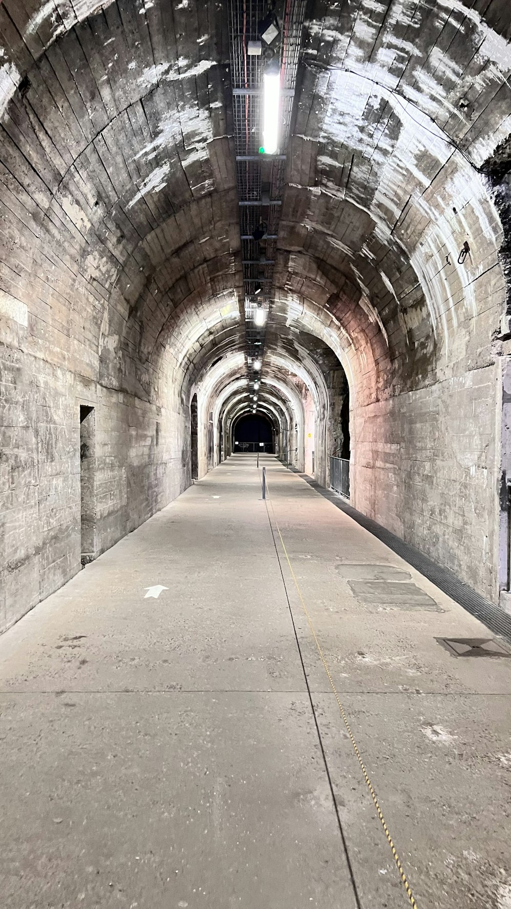 a long tunnel with a clock on the side of it