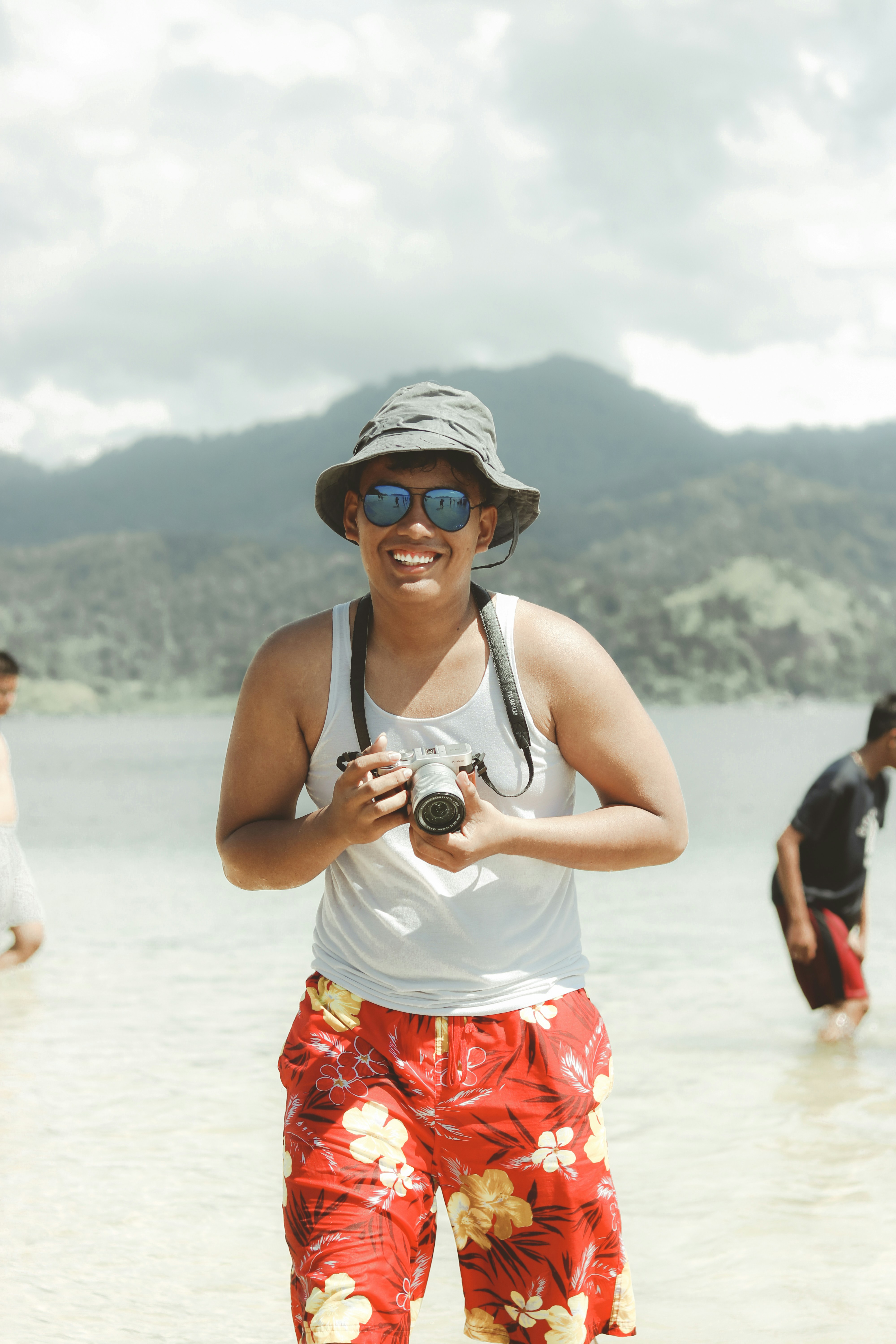 a man standing in the water holding a camera