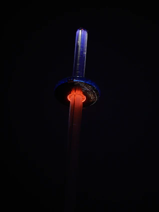 A sleek, futuristic celestial tower glowing softly under a starry night sky.