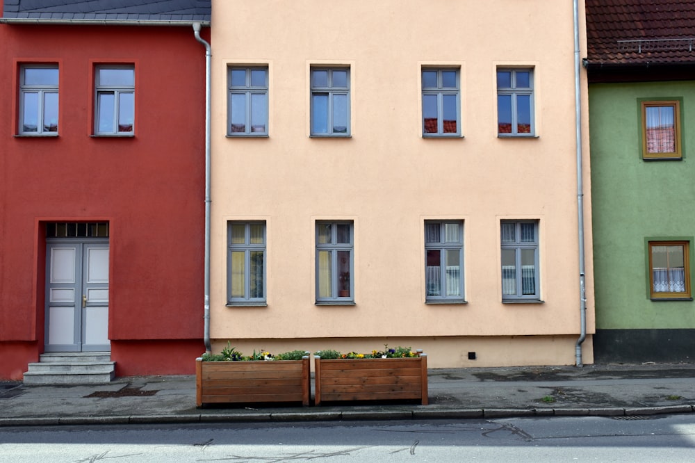 a row of colorful buildings with a planter in front of them