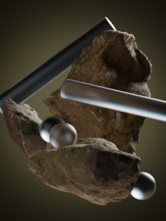 a rock with a metal bar and two balls on it