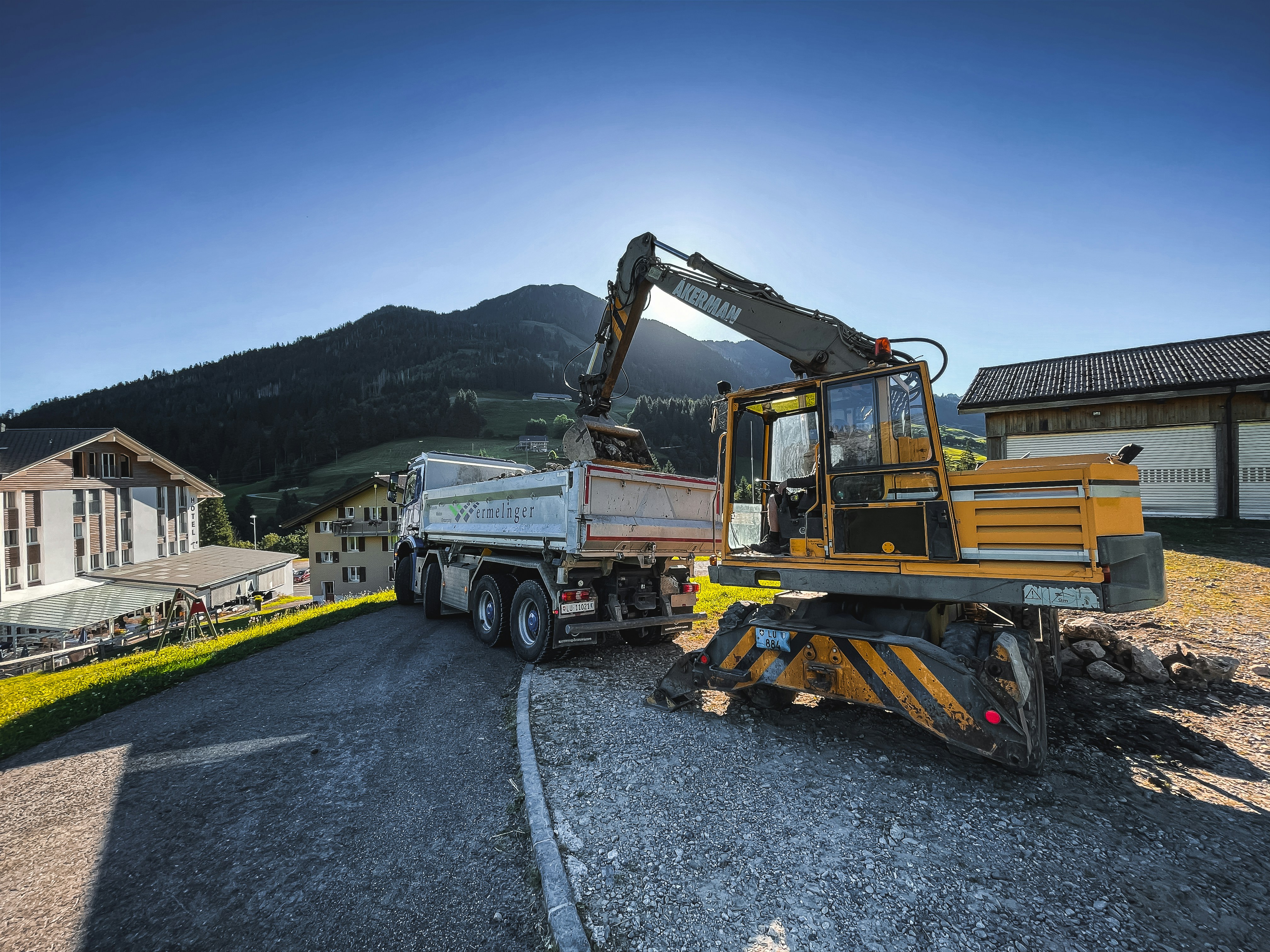 a construction truck is parked on the side of the road