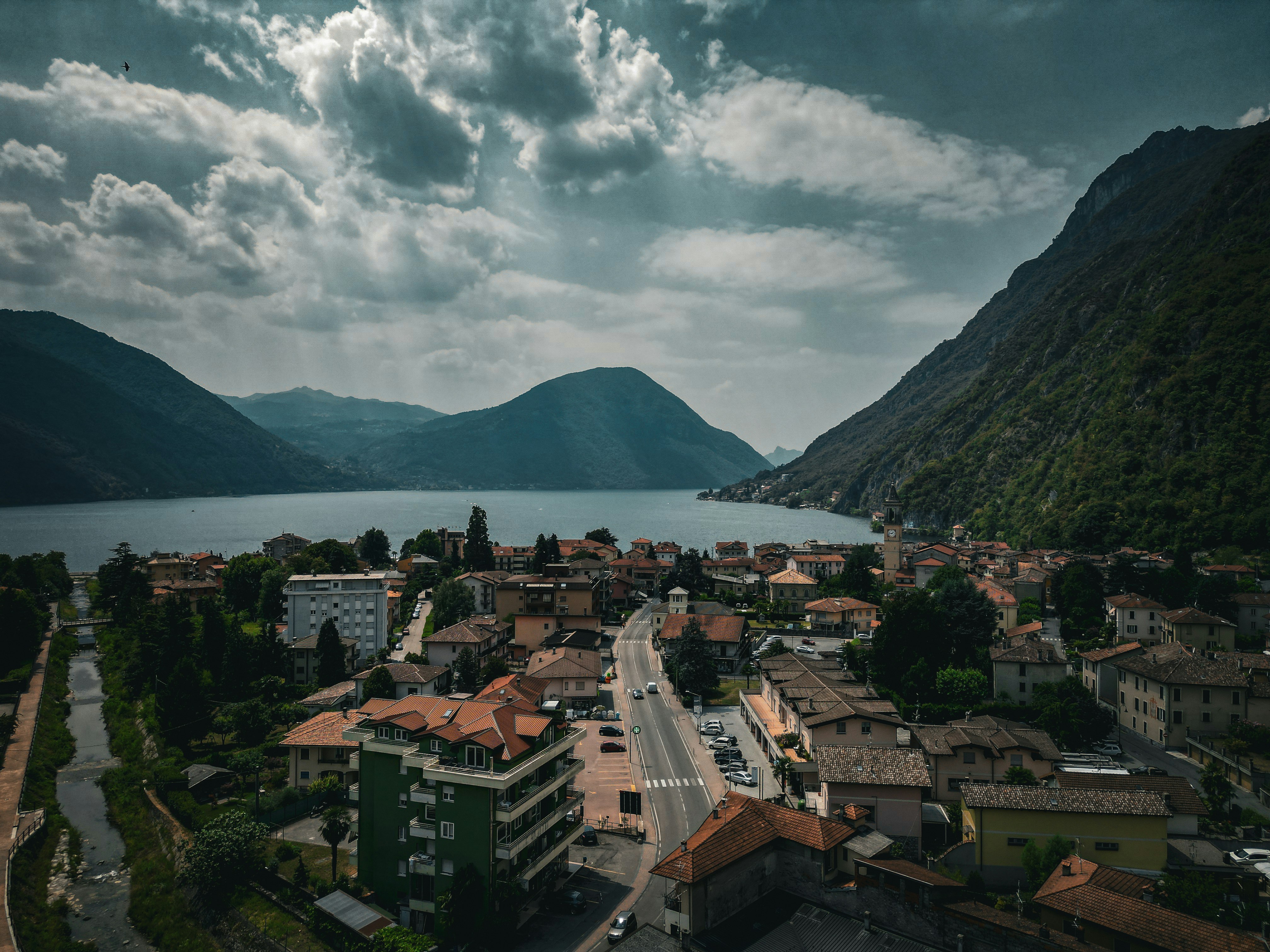 an aerial view of a town with mountains in the background