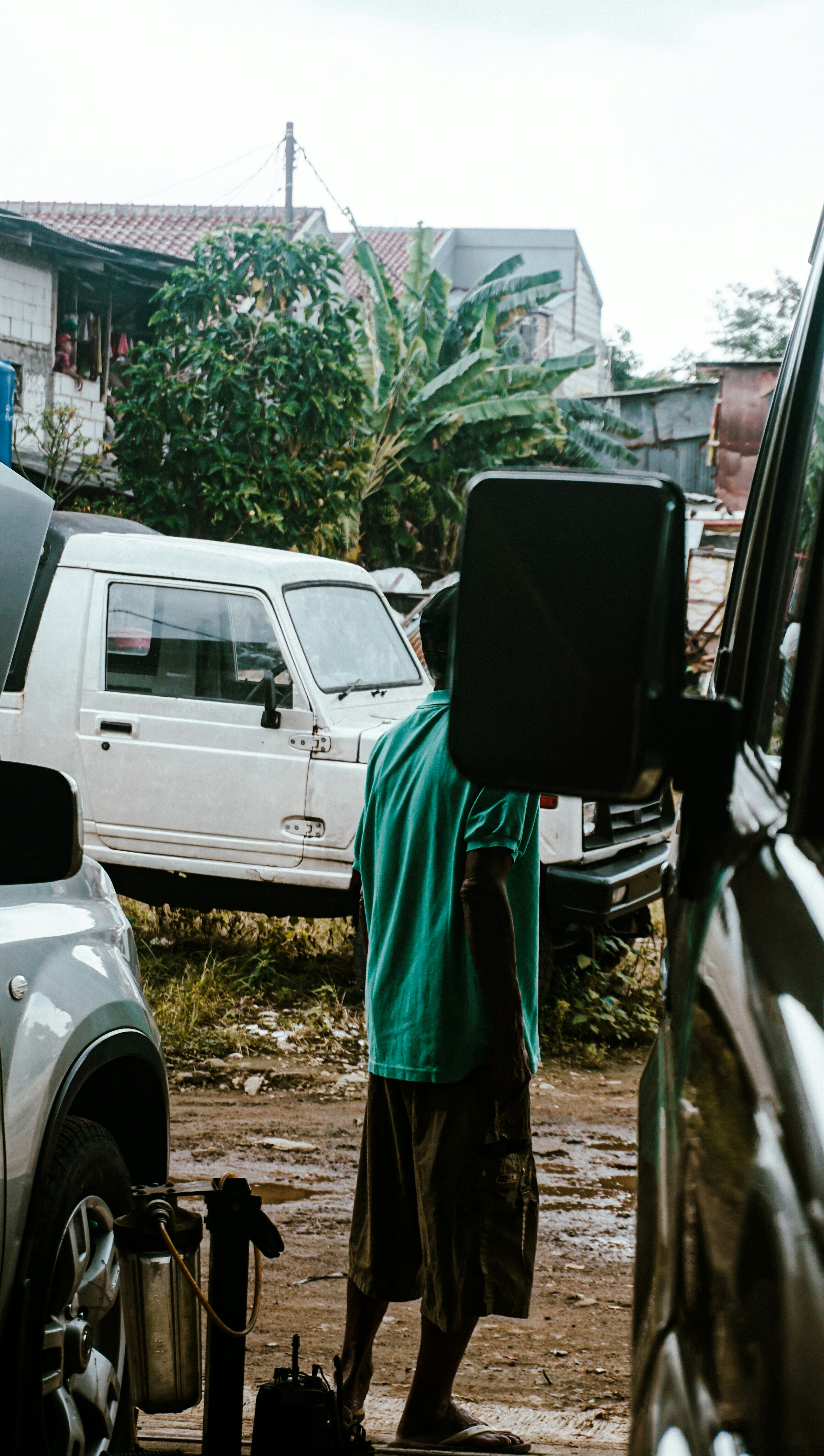 a man standing next to a white truck in a parking lot