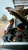 a man working on a car engine in a garage