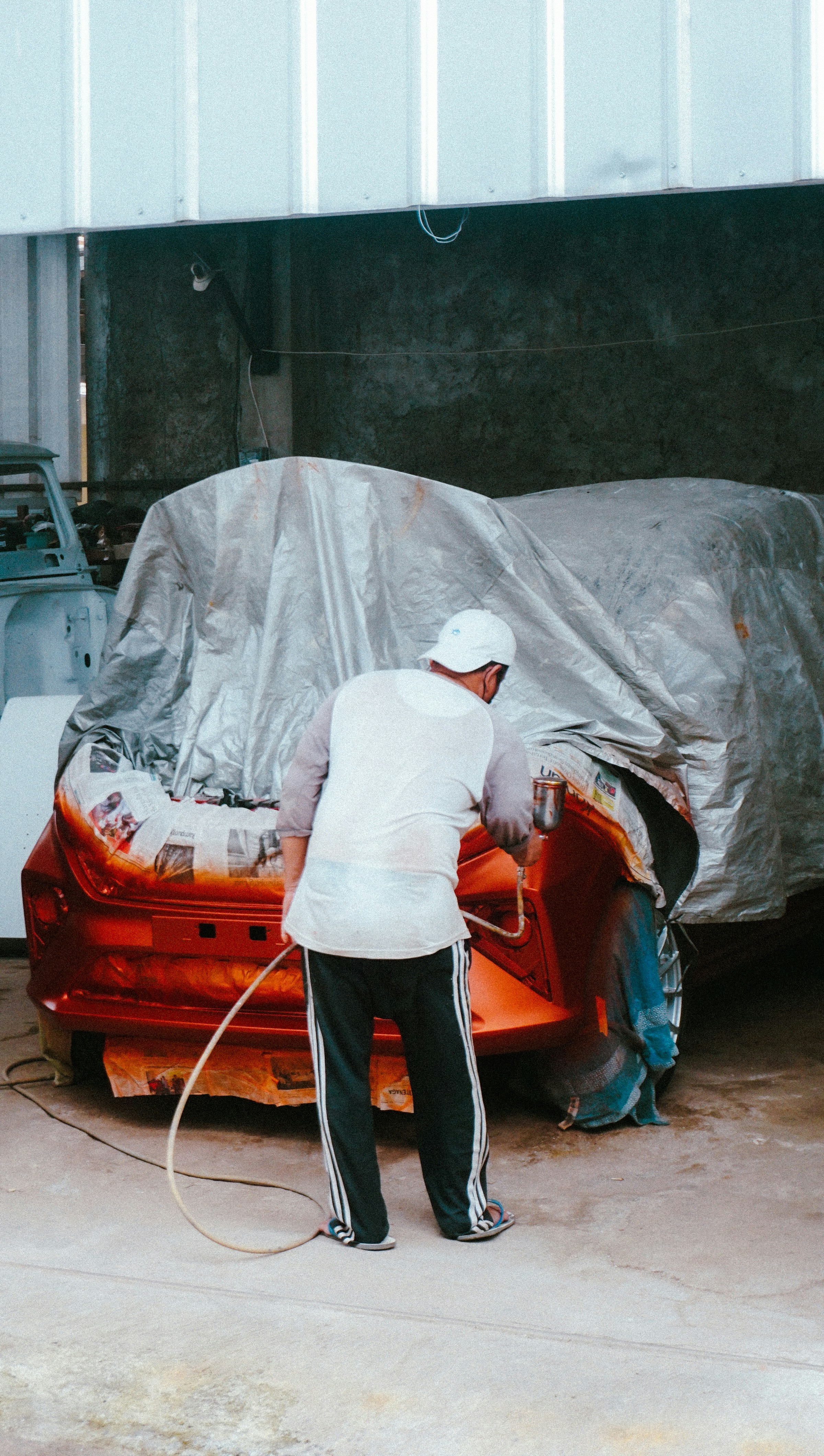 a man working on a car in a garage