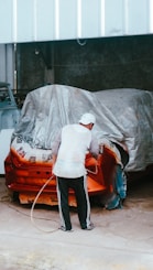 a man working on a car in a garage