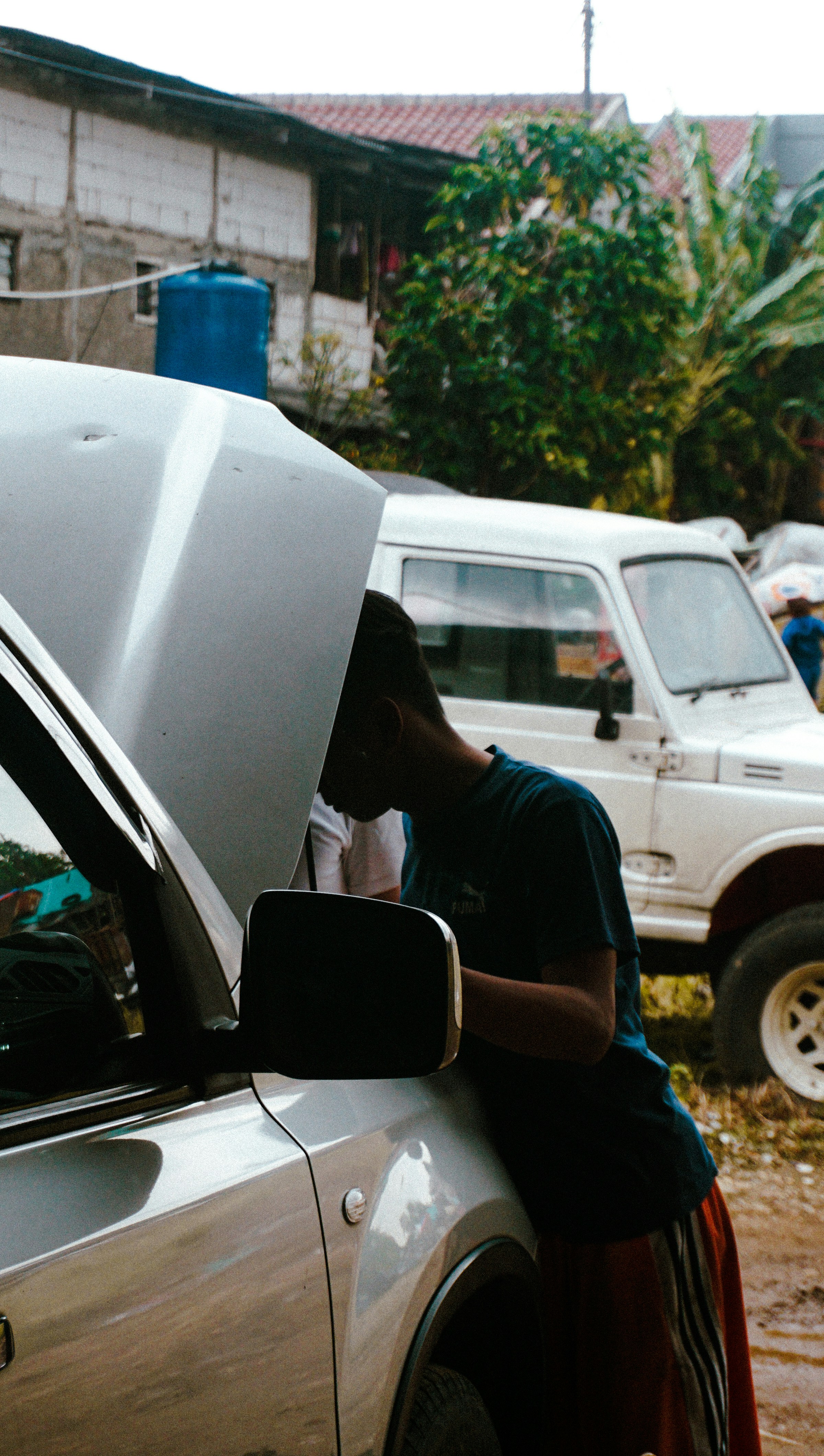 a man standing next to a parked car