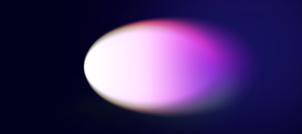 a blurry image of a white ball on a dark background