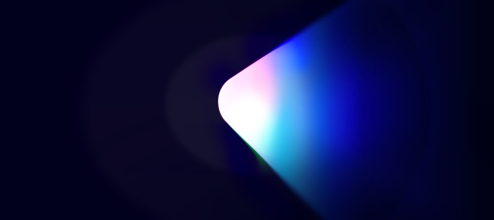 a dark background with a blue and pink light