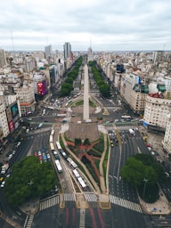 an aerial view of a city with a monument in the middle