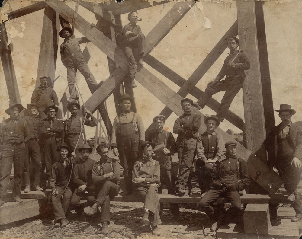 a group of men standing on top of a wooden structure