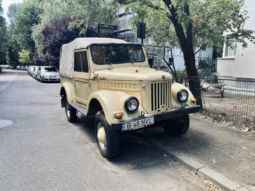 an old truck parked on the side of the road