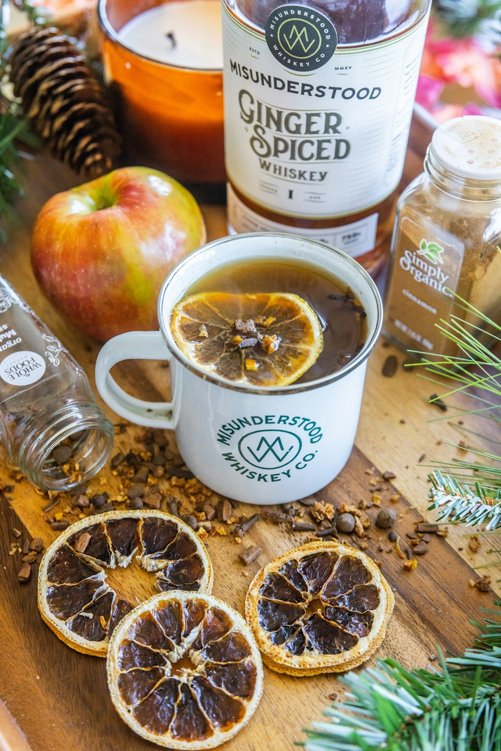 a cup of tea and some sliced oranges on a table