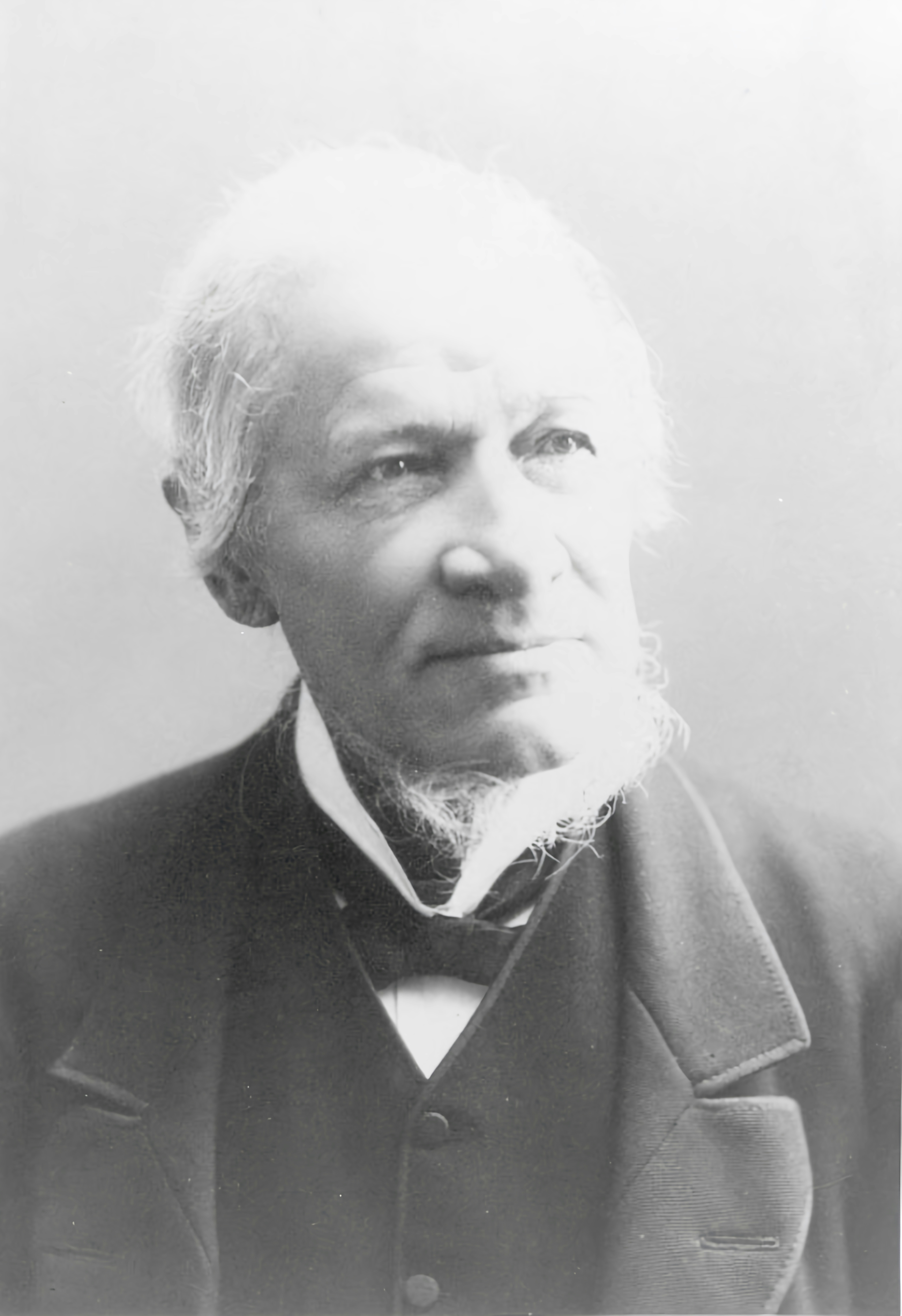 a black and white photo of a man in a suit