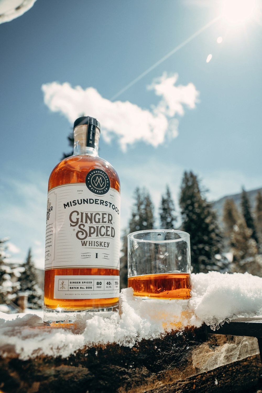 a bottle of ginger spiced next to a glass