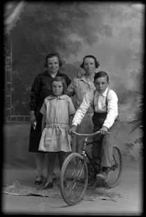a black and white photo of a family posing for a picture