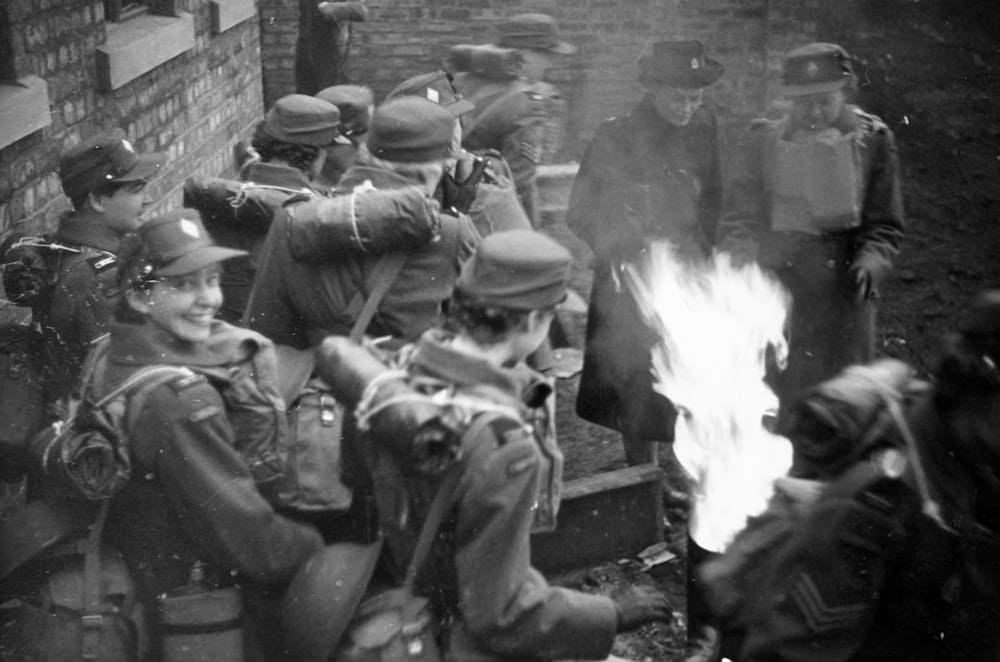 a group of soldiers sitting around a fire
