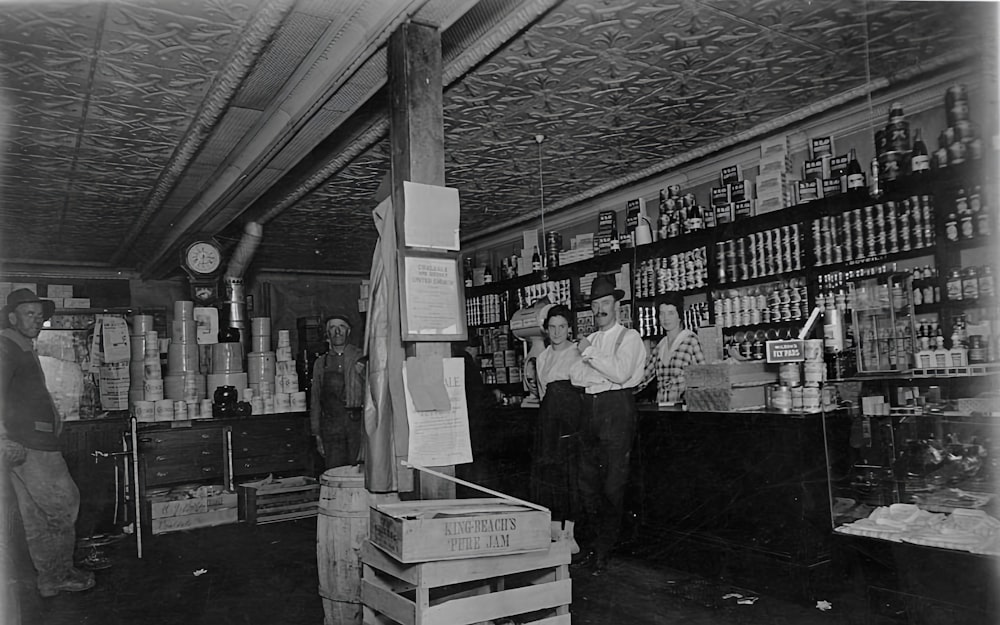 a black and white photo of people in a store