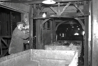 Industrial engineer inspecting conveyor belt splice in a mining facility