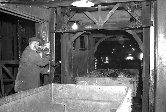 Industrial engineer inspecting conveyor belt splice in a mining facility