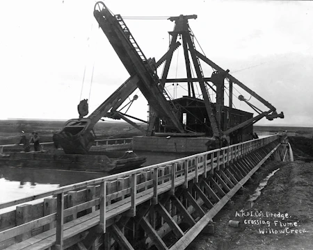 Close-up of a dredging vessel working on the riverbed with industrial equipment