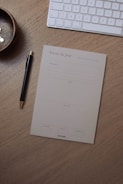 Elegant office desk with a laptop, papers, and a gold pen.