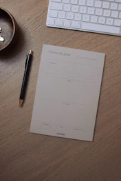 A compact, stylish desk organizer holding pens, notes, and small gadgets.