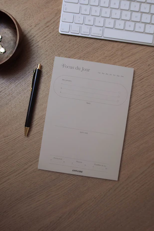 Minimalist wooden desk organizer holding pens and notes on a warm beige surface.