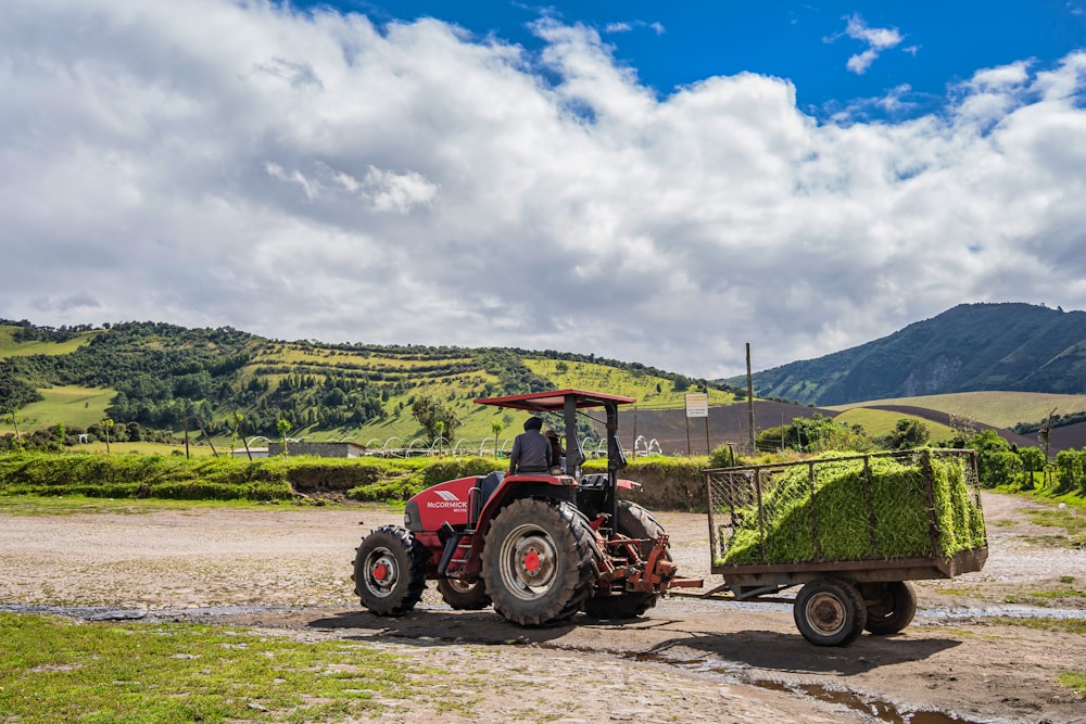 a tractor pulling a trailer full of hay